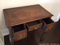 Angled top view showing three drawers open, wood grain and patina