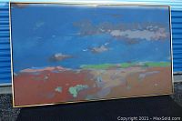 Full front view of painting in gold-tone frame against blue background