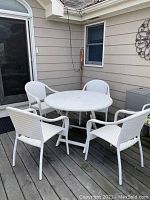 Overview of table with four chairs arranged on deck