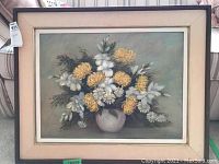 Full view of the framed floral oil painting showing the floral arrangement in a light vase with muted background colors.