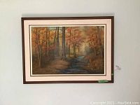 Full front view of framed painting showing autumn forest scene