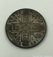 Close up of reverse side of the 1923 UK 1 Florin coin showing heraldic shields and central cross design.