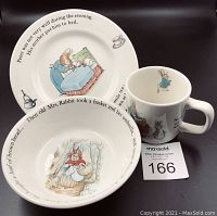 Plate, bowl, and mug set showing front views and story text and illustration details.