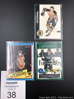 Front view of the three hockey cards featuring Allan Stanley, Wayne Gretzky, and another player with a 1989 highlights card.