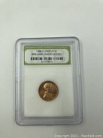 Obverse view of the 1958-D Lincoln Wheat Penny in protective slab, showing the coin and grade label from the International Numismatic Bureau.