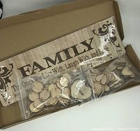 Wooden birthday reminder calendar board inside an open box with small wooden discs for dates and months in plastic bags.