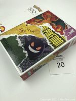 Front of rectangular boxed puzzle with images of Pikachu, Charizard, Gengar and Pokemon 500 pcs label.