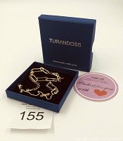 Two gold colour bracelets in a navy blue Turandoss box with a thank you card.
