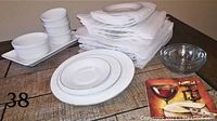 Complete set of Towne House fine china dishes arranged with serving trays, accessory cups, and folded white cloth napkins on wooden surface.