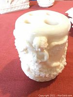 Close-up photo of cream colored Wedgwood melon dish with cherub and floral decorations