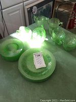 Photo showing the full set arranged on a counter to show quantity and glowing green uranium glass under light.