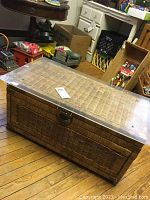 Full view of rectangular woven wicker chest with clear plexiglass top, showing size and shape.