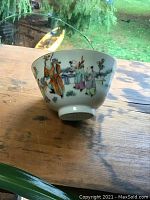 Side view showing hand-painted figures and table scene