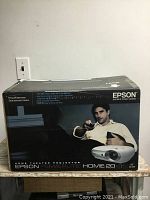 Box front view showing Epson Powerlite Home 20 projector branding and box condition.