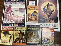 Overall lot showing two signed posters, two hardcover books and three vintage Western magazines from Zane Grey estate.