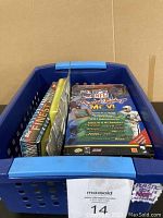Plastic tote filled with multiple football collectible items arranged inside, including card packs and games