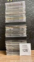 Stack of approximately 35 CD cases in jewel cases, showing spines and tops of cases, arranged upright.