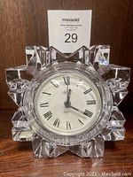 Front view of Mikasa crystal quartz clock with geometric starburst crystal pattern and visible clock face.