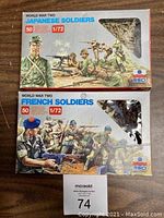 Photo showing two boxed sets of 1/72 scale World War II toy soldiers: Japanese soldiers set and French soldiers set. Both boxes display vintage style illustrations and indicate 50 pieces per box.