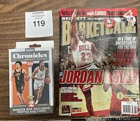 Photo of the sealed 2021 Panini Chronicles Draft Picks basketball card hanger box alongside the Beckett Basketball Collectibles magazine showing Michael Jordan on the cover.
