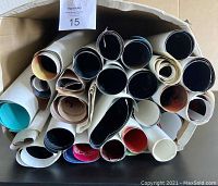 Top-down view of the lot showing numerous rolled posters packed together.