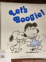 Front cover of the white Peanuts Snoopy binder titled 'Let's Boogie!' with dancing Snoopy and character illustration.