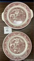 Photo of larger Willow Ware plate with handles showing red and white Asian-inspired pattern and minor chip on underside not visible on top