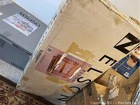 Photo of the boxed Nelson wooden changing table showing the large cardboard box with product image and brand visible.