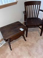 Photo of the wooden commode stool with chamber pot inside and the wooden chair beside it.
