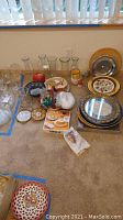 Wide view of all items showing glass vases, serving platters, cheese cutter box, and decorative plates.