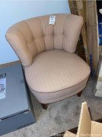 Full view of upholstered side chair showing curved backrest and seat.