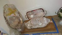 Multiple silver plated platters stacked and packaged together