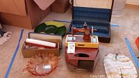 Overview of lot with toy sewing machine, shoe shiner, rose glass bowl, silverware chest and green glass dish