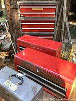 Three red steel Craftsman stacking toolboxes on metal frame