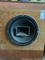 Front view of plywood cabinet showing large woofer and horn