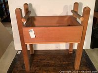 Full view of the hardwood potting or soil mixing table showing structure and overall condition.