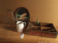 Photo showing all six items: wire milk holder, white ceramic pitcher, wooden Towne Club beverage tray, clear vintage bottle, green Coca-Cola bottle, and White Rock metal serving tray