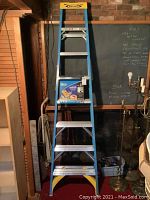 Full view of the 8-foot Werner fiberglass stepladder, standing upright with visible steps and tool tray at top.
