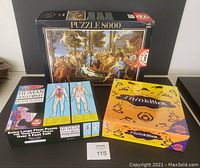 Three items shown together: 8000-piece Educa puzzle box, Human Anatomy Floor Puzzle box, and sealed ThinkBlot game box.