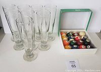 Set of 8 clear Catalina beer glasses and boxed 16 pool balls shown together.