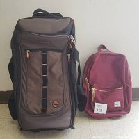 Both bags shown side by side on floor against a wall