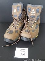 Front view of pair of brown and gray Vasque Gore-Tex hiking boots with laces and visible logo on tongues.