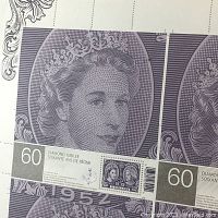 Close up of Queen Elizabeth II portrait stamps on souvenir sheet showing 60 Diamond Jubilee text and detailed engraving.