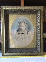 Full view of the framed hand painted vintage photograph, showing girl portrait and ornate frame with gilded mat.
