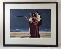 Front view of the framed decorative print showing the three figures on a beach with a dark sky, matted and in a black frame.