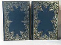 Two volumes of books with blue covers and ornate gilt decoration on the front.
