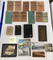 Overview of all items: Missouri Agricultural Account Books, green ledgers, Essex farmers book, prayer books, vintage postcards, and mounted photo.