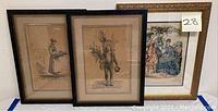 Three framed portrait prints shown side by side, two with brown toned folk harvesting subjects, one colorful fashion illustration framed in gold