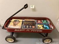 Full view of the Radio Flyer wagon containing baseball books inside.