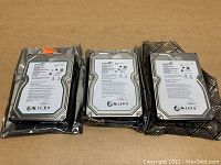 Three Seagate Barracuda hard drives in anti-static bags showing top labels and product information.